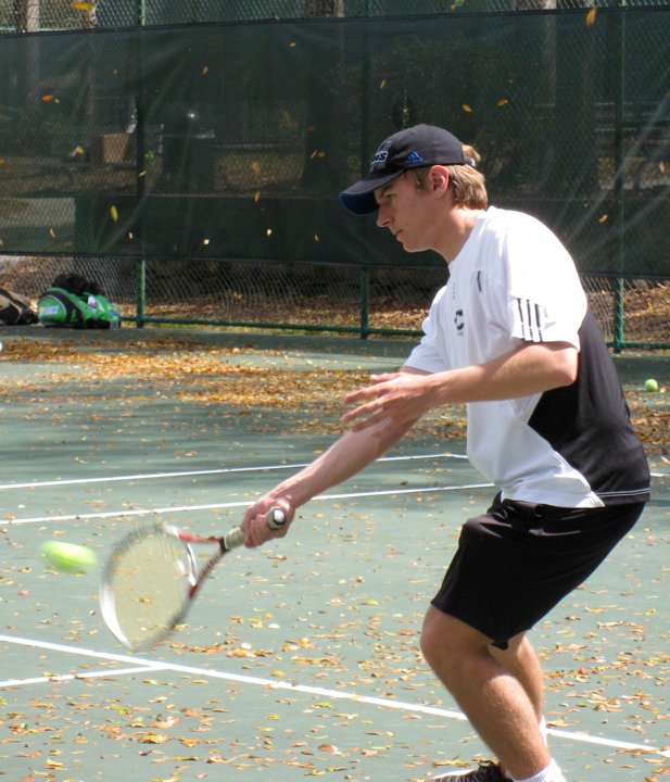 College tennis player hitting a forehand volley