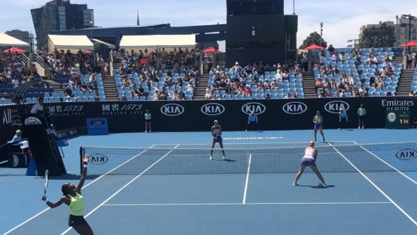 Coco Gauff prepares to serve during a 2020 Australian Open doubles match.