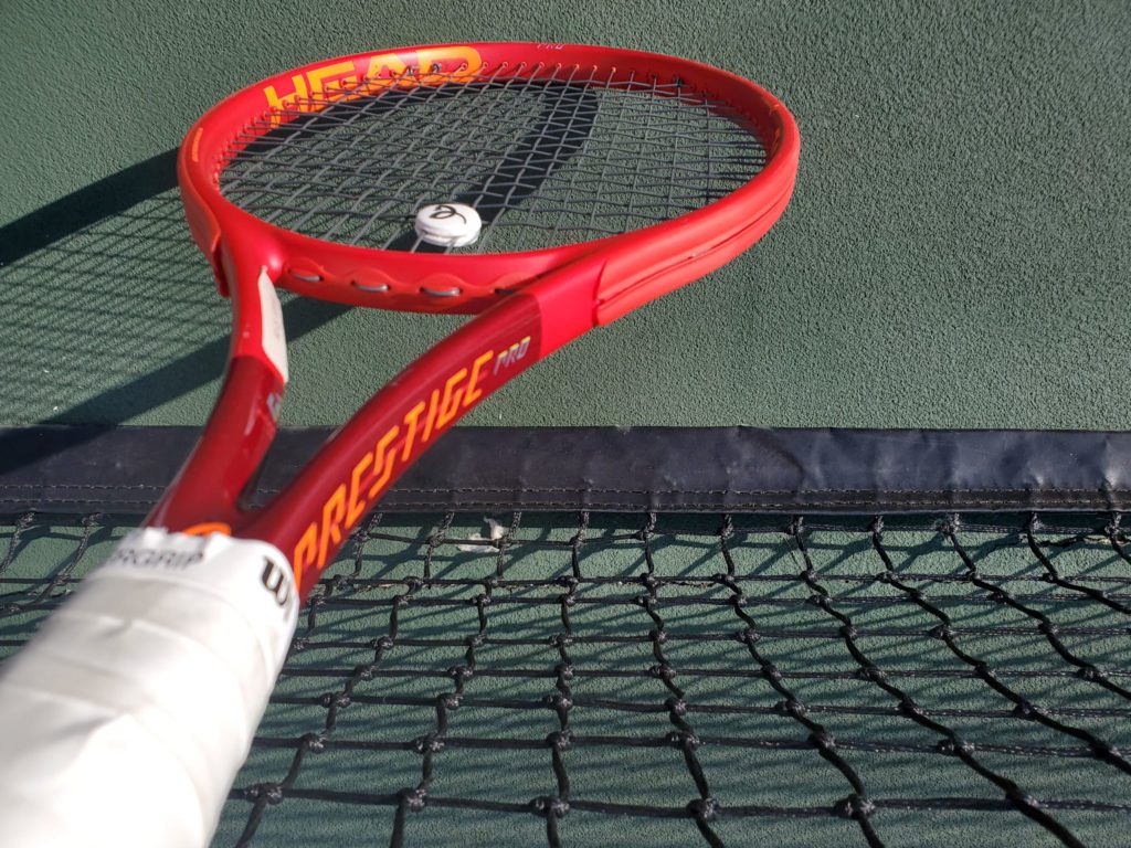 Head Prestige Pro Tennis Racquet standing up on the tennis court