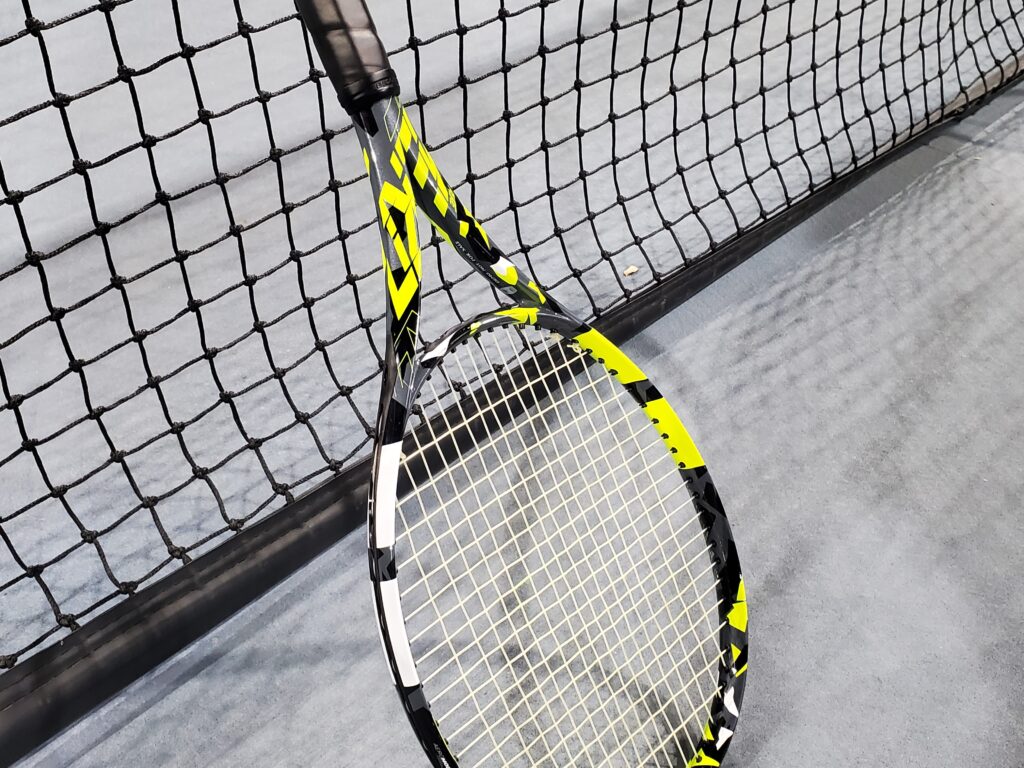 Babolat Pure Aero tennis racquet on the net