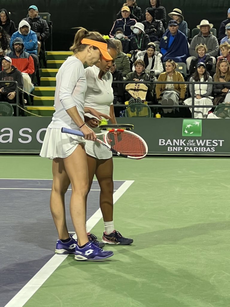 Doubles partners Alize Cornet and Leylah Fernandez discussing shot selection at the 2022 Indian Wells Masters.
