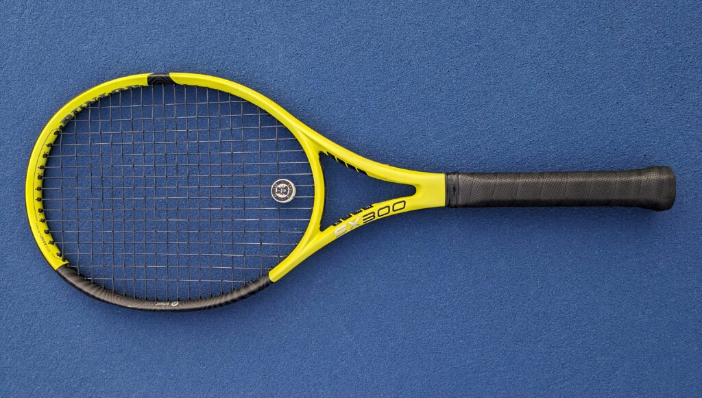 Dunlop SX tennis racquet laying down on tennis court