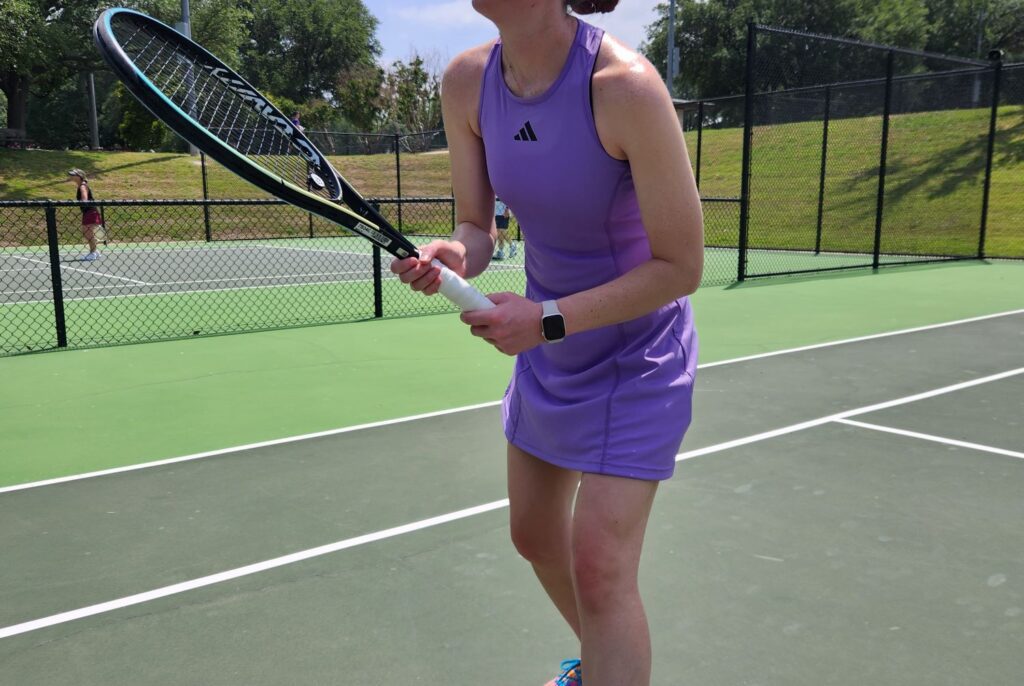 Girl playing tennis in Adidas dress