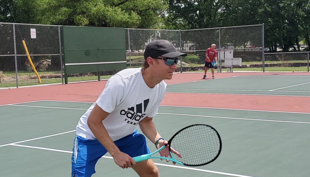 Beginner tennis player using the Head Boom racquet