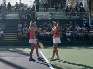 Doubles partners congratulating each other on the court