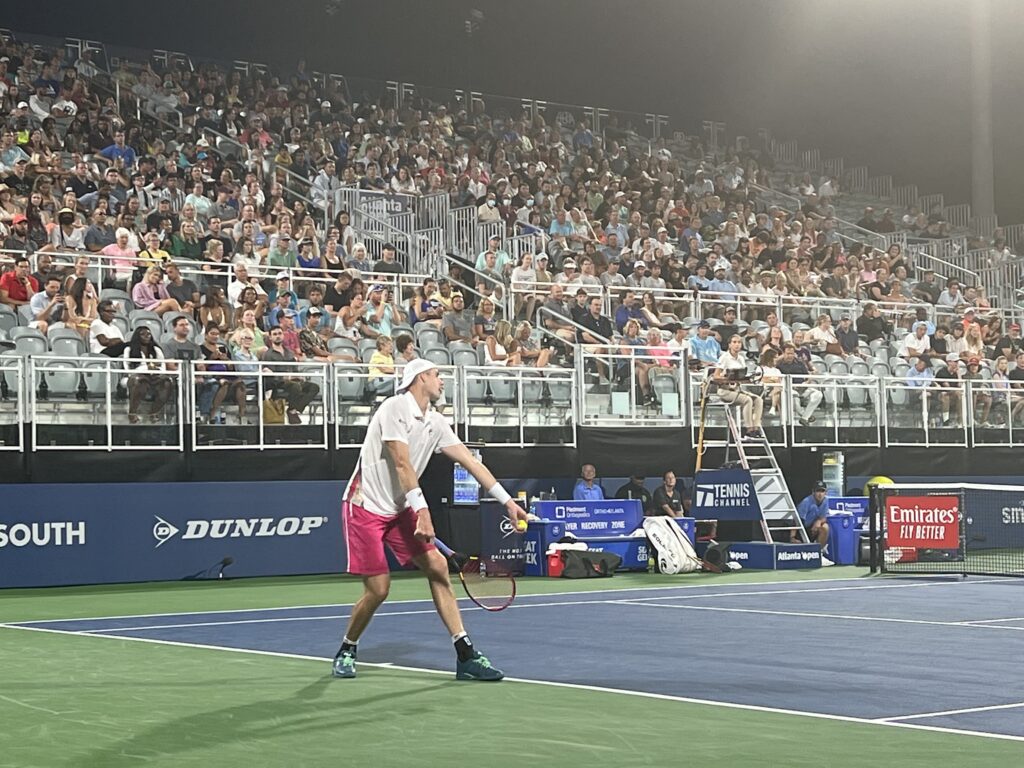 John Isner prepares to hit a serve at the 2022 Atlanta Open