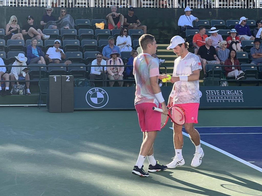 Neal Skupski and Wesley Koolhoff talk doubles strategy during their match at Indian Wells in 2022. 