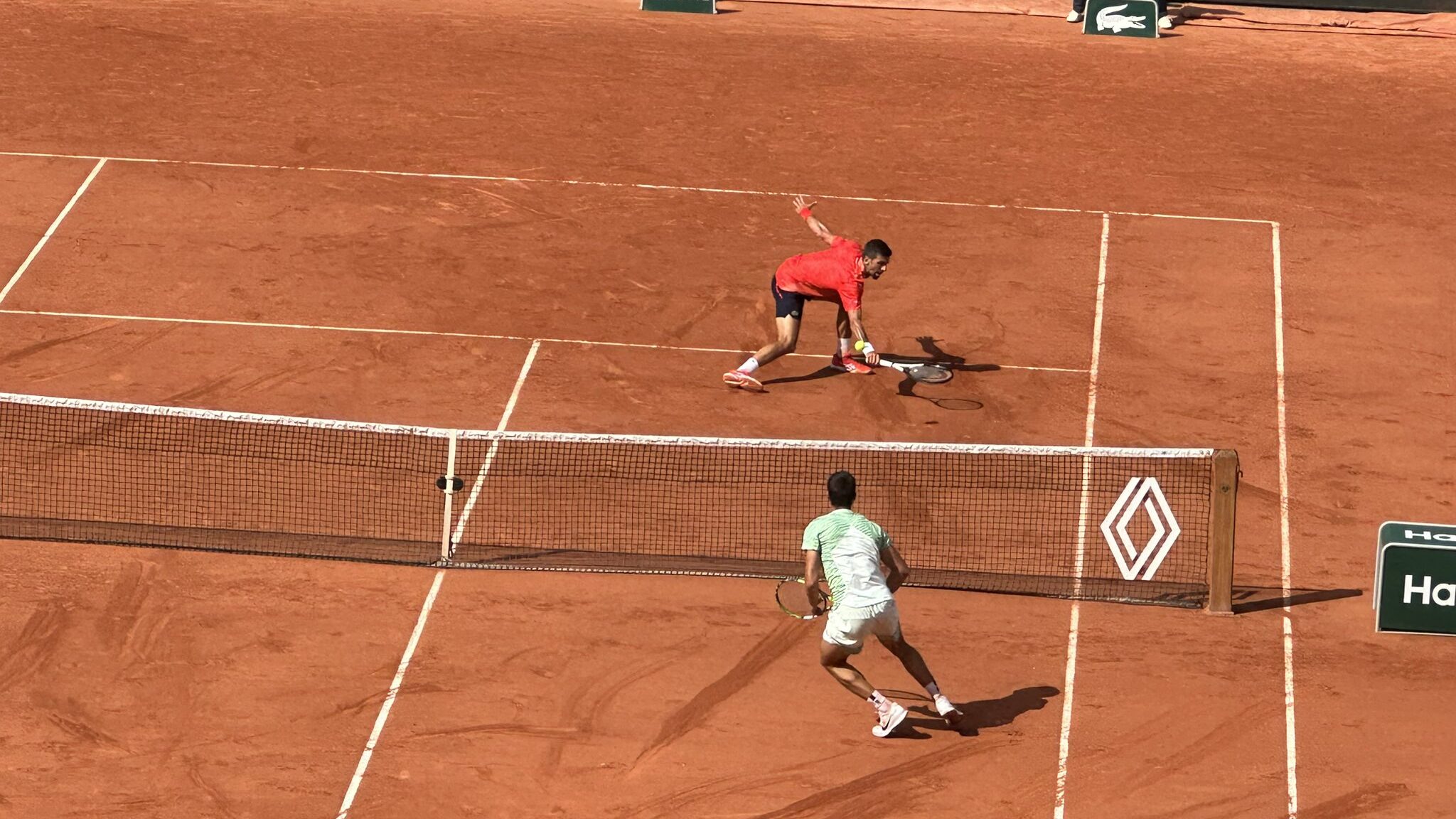 Novak Djokovic hits a volley