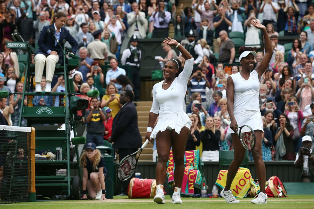 Serena and Venus celebrate their 14th major doubles title at Wimbledon in 2016. 