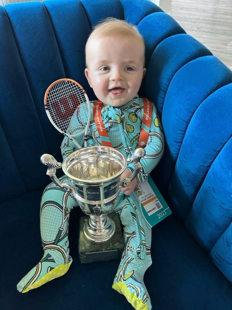 Philip Farmer's son with a trophy and tennis racquet